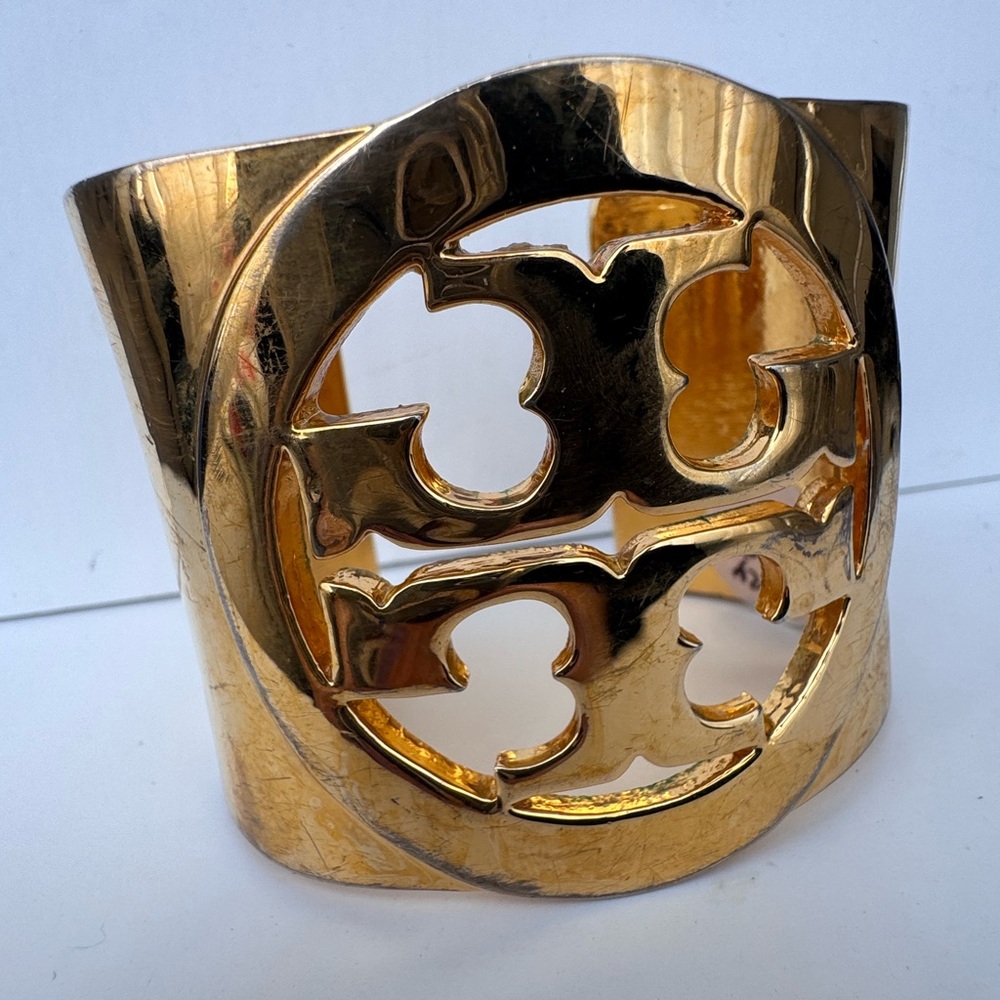 Bold gold plated  cuff with signature Tory Burch emblem